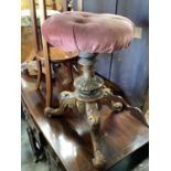Victorian piano stool with revolving adjustable pink upholstered seat on three carved legs