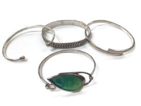 Silver bangle with green enamelled leaf decoration together with other three silver/white metal bang