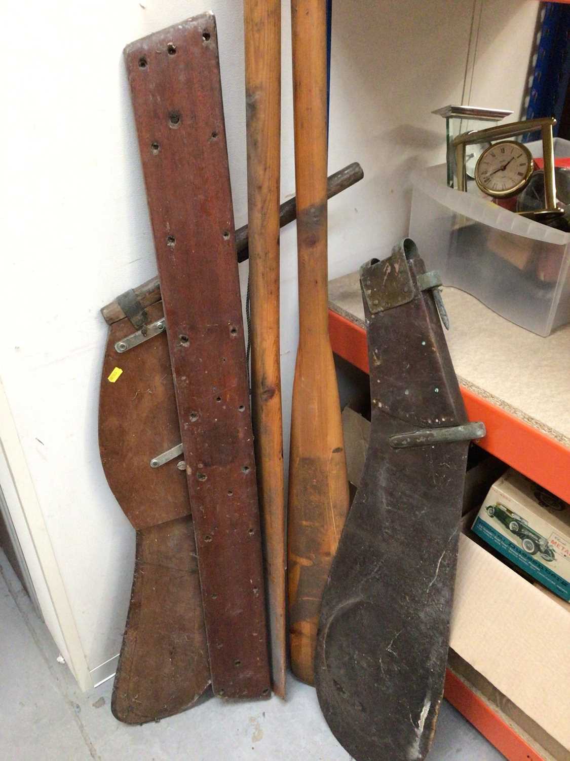 Pair of wooden rowing oars and two wooden sailboat rudders