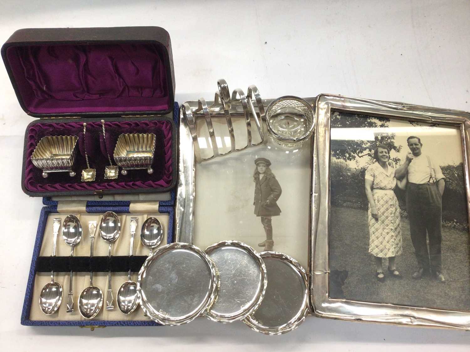 Two silver photograph frames, cased set of silver salts, set of six silver teaspoons, silver toast r