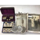 Two silver photograph frames, cased set of silver salts, set of six silver teaspoons, silver toast r