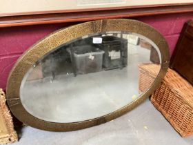 Early 20th century hammered brass framed oval mirror