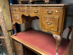 Georgian style walnut kneehole desk with inset leather lined top and five drawers below on carved ca