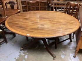 Nineteenth century mahogany oval tilt top breakfast table with crossbanded decoration on turned colu