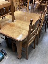 Edwardian oak extending dining table with two extra leaves opening to 205cm x 103cm, together with a
