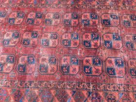 Antique Persian design rug with geometric medallions on dark red ground