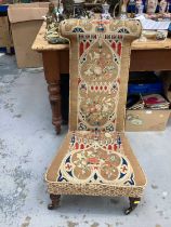 Victorian prie dieu chair with tapestry upholstery, on turned legs and brass capped castors