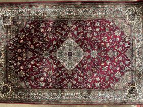 Two good quality Persian silk rugs together with a part silk rug (3)