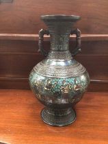 An unusual Chinese enamelled bronze vase decorated with a frieze of Egyptian figures