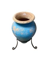 Painted terracotta Amphora shape garden pot on iron stand, 69cm high and another