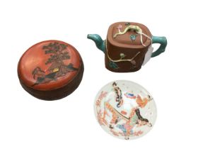 Chinese terracotta teapot, Japanese lacquer box and cover and a Japanese porcelain saucer (3)
