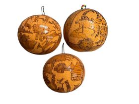 Set of three West African, Gambia, hand carved gourds depicting animals and African villages