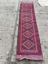 Persian runner with seven medallions on red ground, 250cm x 56cm