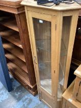 Contemporary light oak glazed corner cupboard with glass shelves and panelled door below together wi