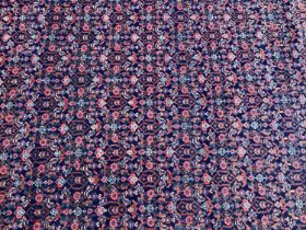 Persian design rug on red and blue ground