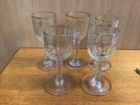 Set of five Georgian facet cut wine glasses with gilt swag decoration