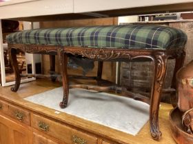 Good quality mahogany long footstool with tartan upholstery on six carved cabriole legs joined by sh