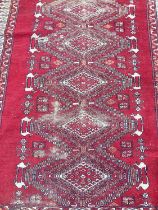 Eastern rug with six central medallions on red and cream ground, 167cm x 123cm