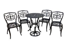 Wrought iron circular garden table and four matching chairs