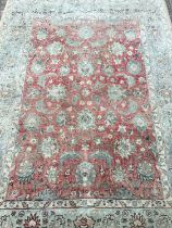 Rug with floral decoration on red and pale blue ground, 200cm x 145cm