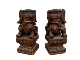Pair of carved wooden temple lions.