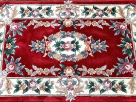 Chinese rug with floral decoration on red and cream ground, 158cm x 89cm, together with another, 160