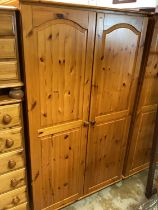 Two modern pine double wardrobes, 104cm wide, 56cm deep, 176.5cm high, together with a pine dresser,