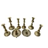 Three pairs of Georgian brass candlesticks and two chamber sticks