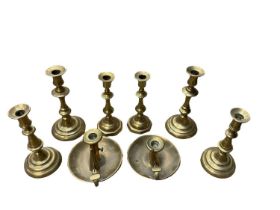 Three pairs of Georgian brass candlesticks and two chamber sticks