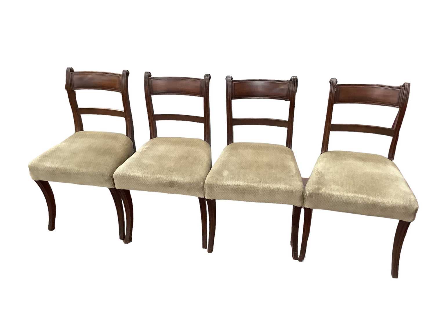 Set of four Regency mahogany dining chairs, each with tablet back and stuffover seats, on sabre legs