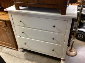 Hardwood coffee table with wrought iron brackets and a white chest of drawers