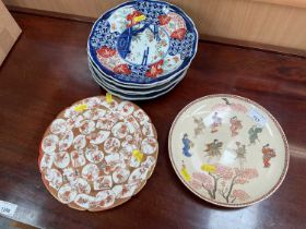 Six matching Imari plates, one Kutani plate, one Satsuma plate depicting figures, signed