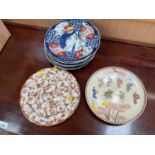 Six matching Imari plates, one Kutani plate, one Satsuma plate depicting figures, signed