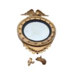 19th century convex wall mirror in gilt wood frame with ebonised slip and eagle surmount, approximat