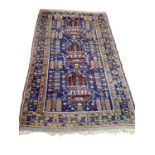 Eastern rug with geometric decoration on blue, green and brown ground, 196cm x 111cm