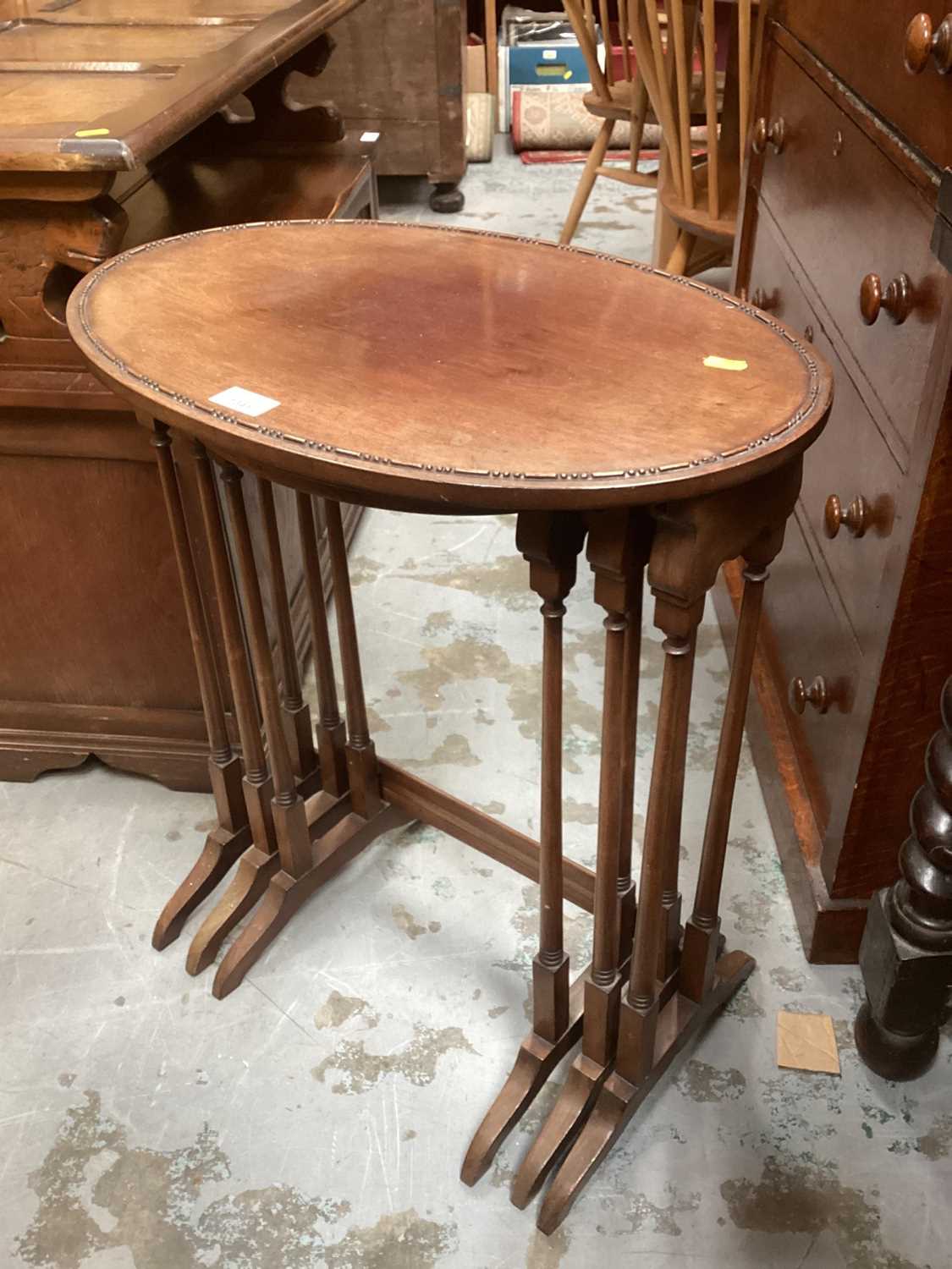 Edwardian mahogany nest three oval coffee tables on colomn supports