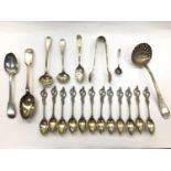 Group of silver and white metal spoons and pair of silver sugar tongs, in a brass inlaid box