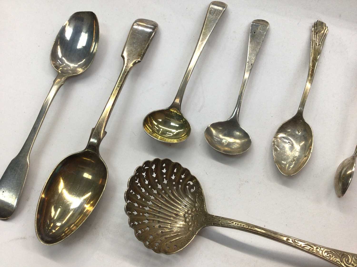 Group of silver and white metal spoons and pair of silver sugar tongs, in a brass inlaid box - Image 2 of 4