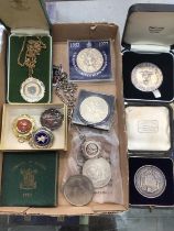 Two silver medallions in fitted cases, silver fob on plated chain, other fobs and coins
