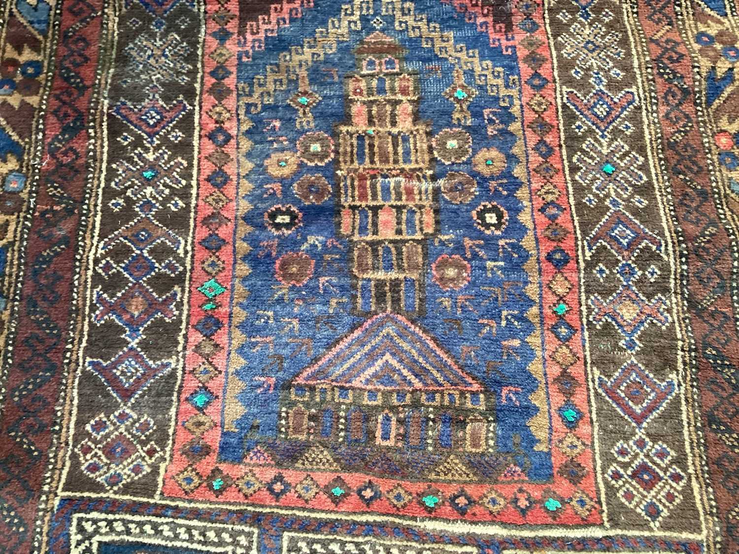Eastern rug decorated with buildings on red, blue and brown ground, 128cm x 80cm - Image 2 of 4