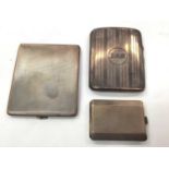 Two silver cigarette cases and a silver matchbook case (3)