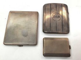 Two silver cigarette cases and a silver matchbook case (3)