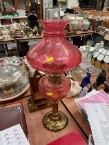 Cranberry glass and brass oil lamp with shade