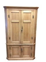 Antique pine two height corner cupboard with shelved interior enclosed by four panelled doors, 120cm