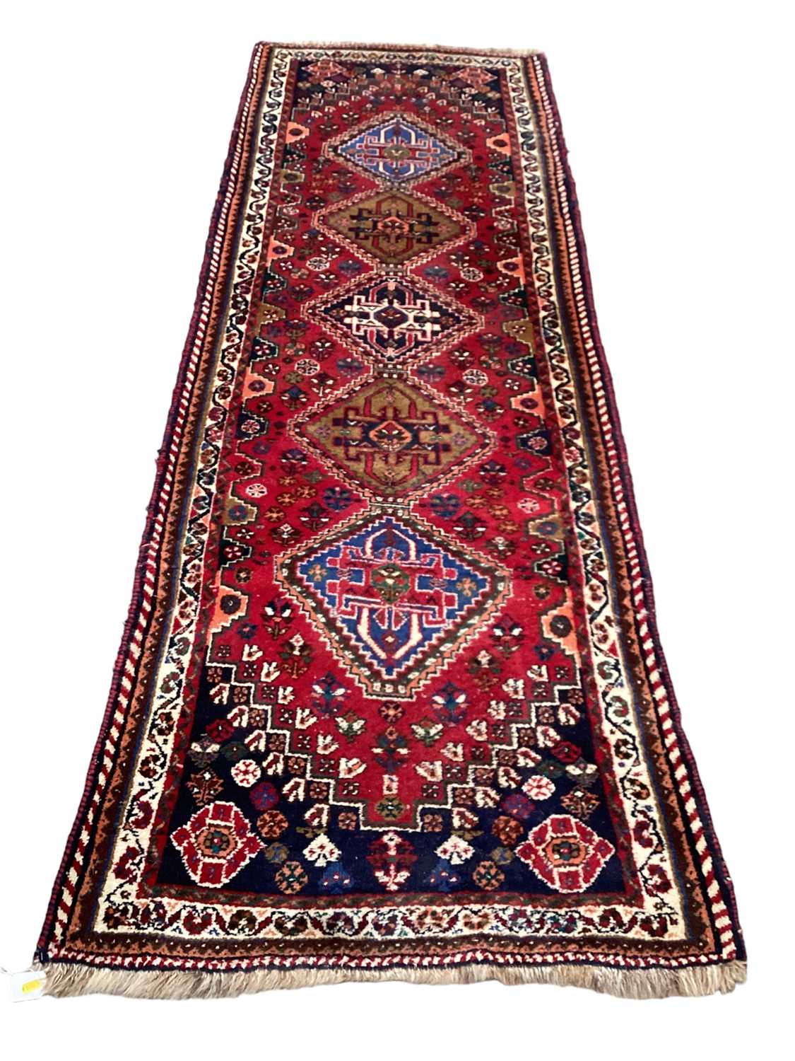 Persian runner with five central medallions on red, blue and cream ground