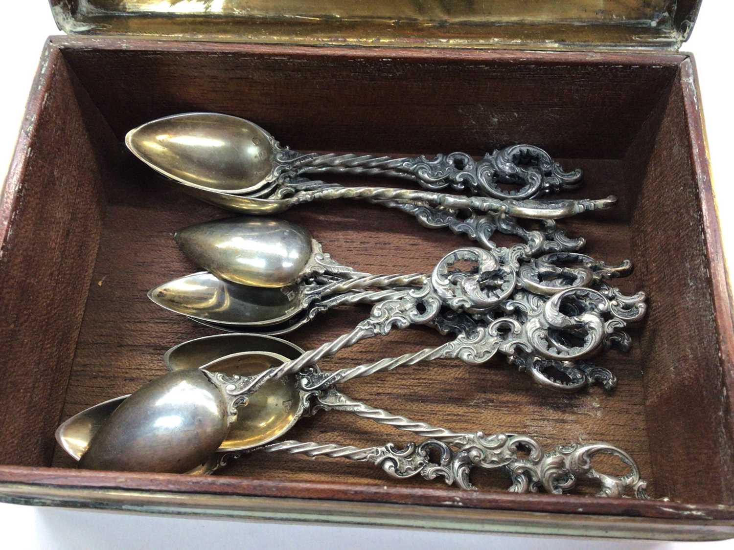 Group of silver and white metal spoons and pair of silver sugar tongs, in a brass inlaid box - Image 3 of 4