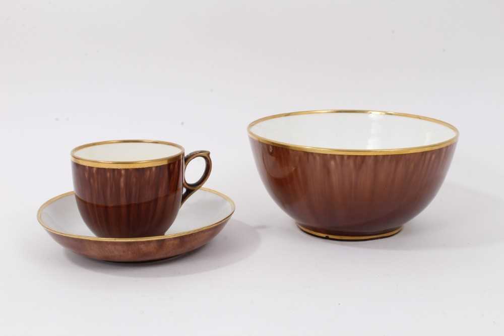 A Rockingham tortoiseshell glazed teacup, saucer and a bowl, circa 1840