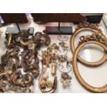 Group of decorative gilt metal mounts, wall mounted hooks etc, pair of oval gilt frames and two carv