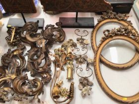 Group of decorative gilt metal mounts, wall mounted hooks etc, pair of oval gilt frames and two carv
