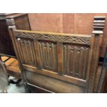 Early 20th century carved oak single bedstead with linen fold panels